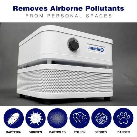 A white, personal-sized HEPA air purifier with labels indicating it removes airborne pollutants such as bacteria, viruses, particles, pollen, spores, and dander.