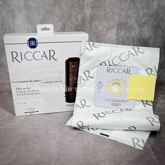 A pack of Riccar HEPA vacuum bags displayed alongside their packaging which has the brand name and product information visible.