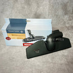 Miele parquet twister with packaging on a gray surface