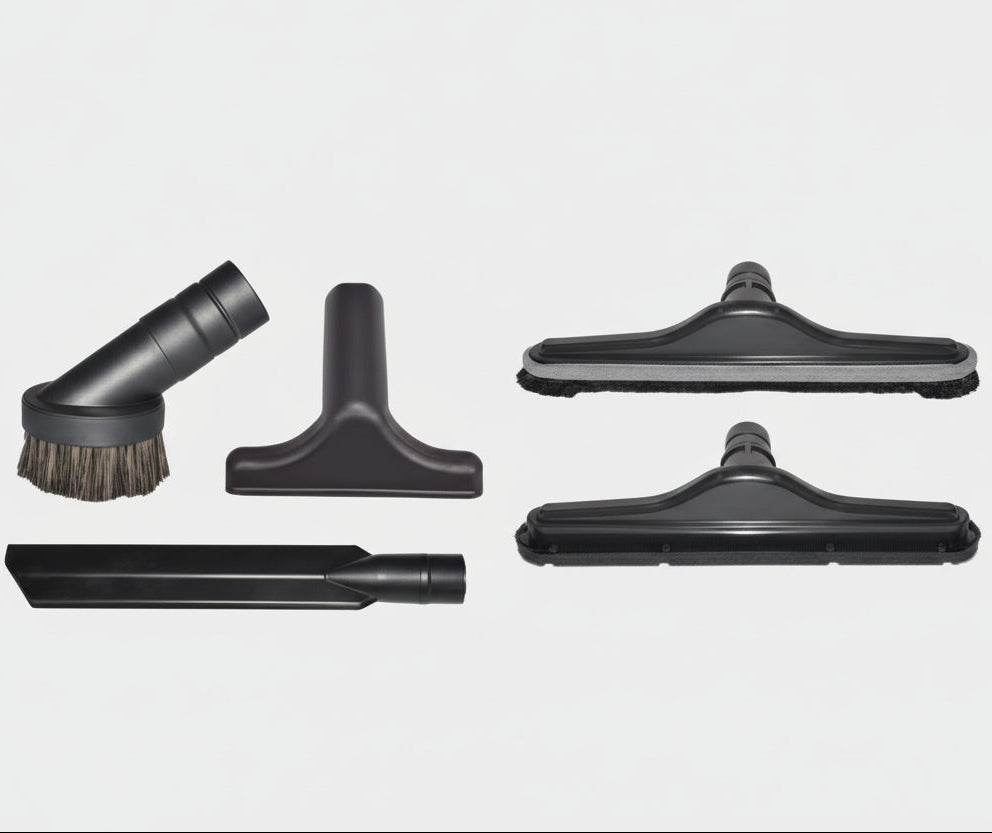 Set of black vacuum attachments on a light gray background